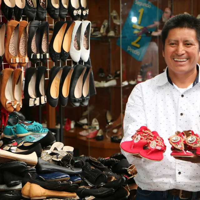 Businessman holding shoes