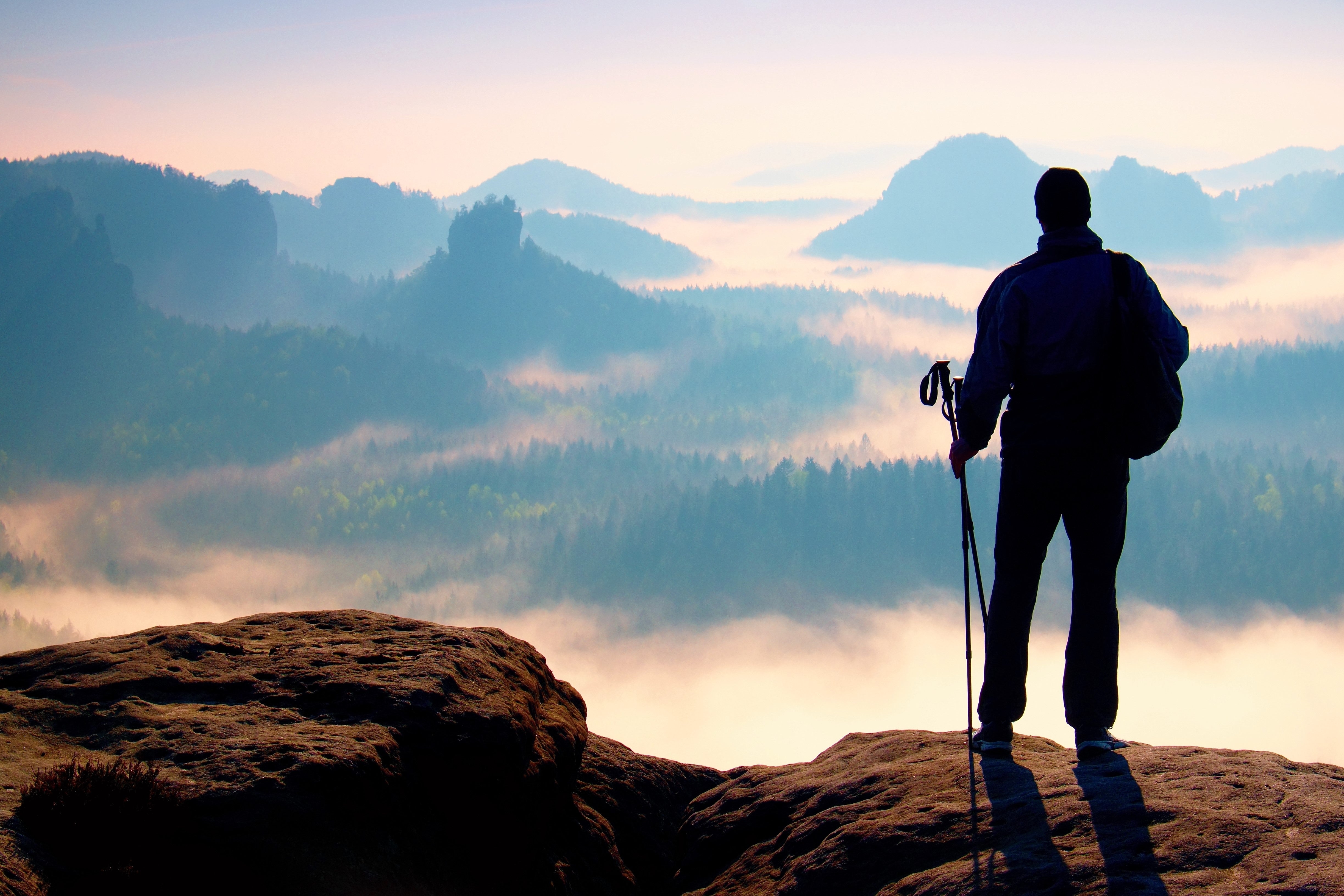 Picture of man standing overlooking a cliff