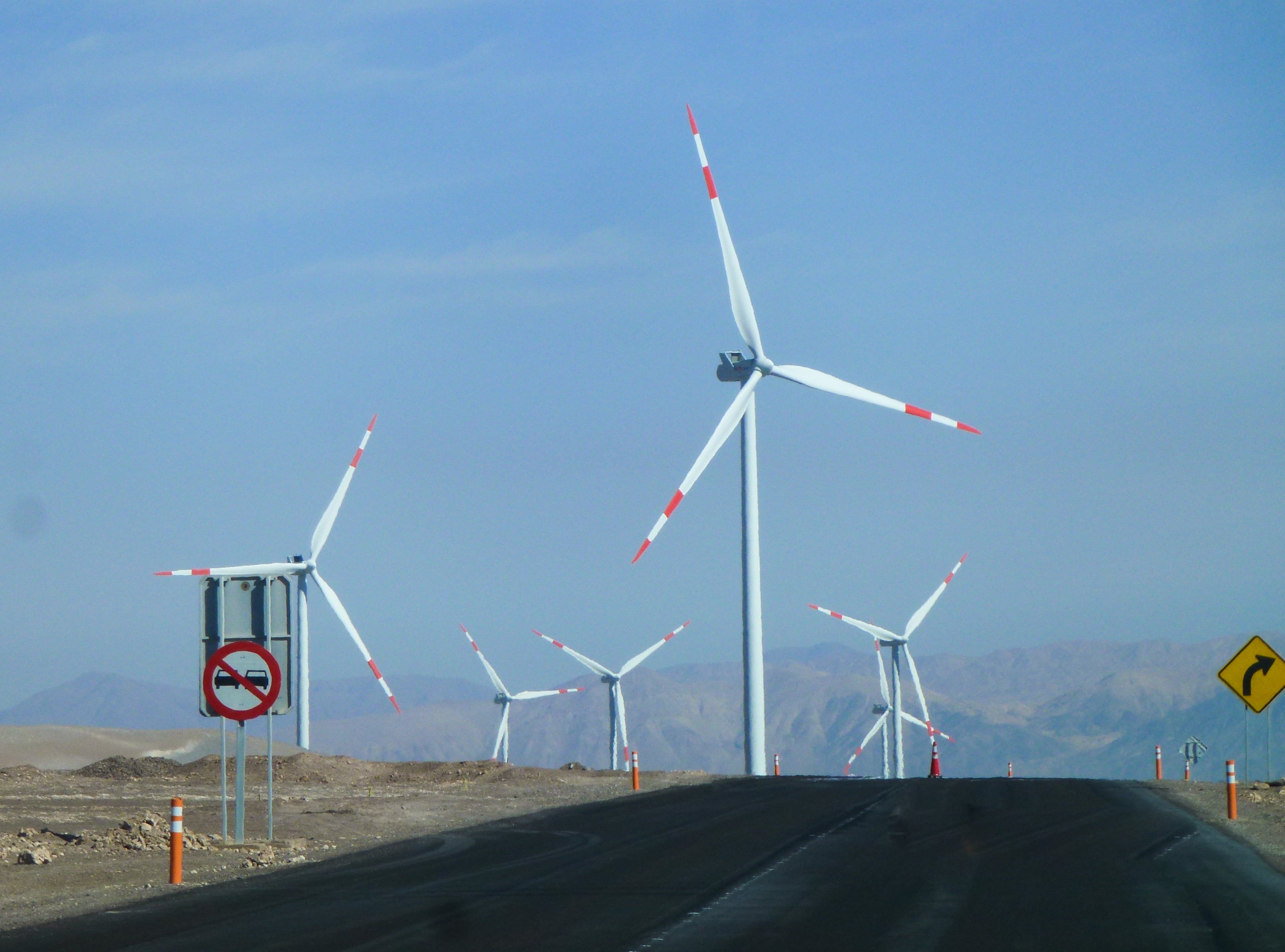 View of a road with several windmills in the background