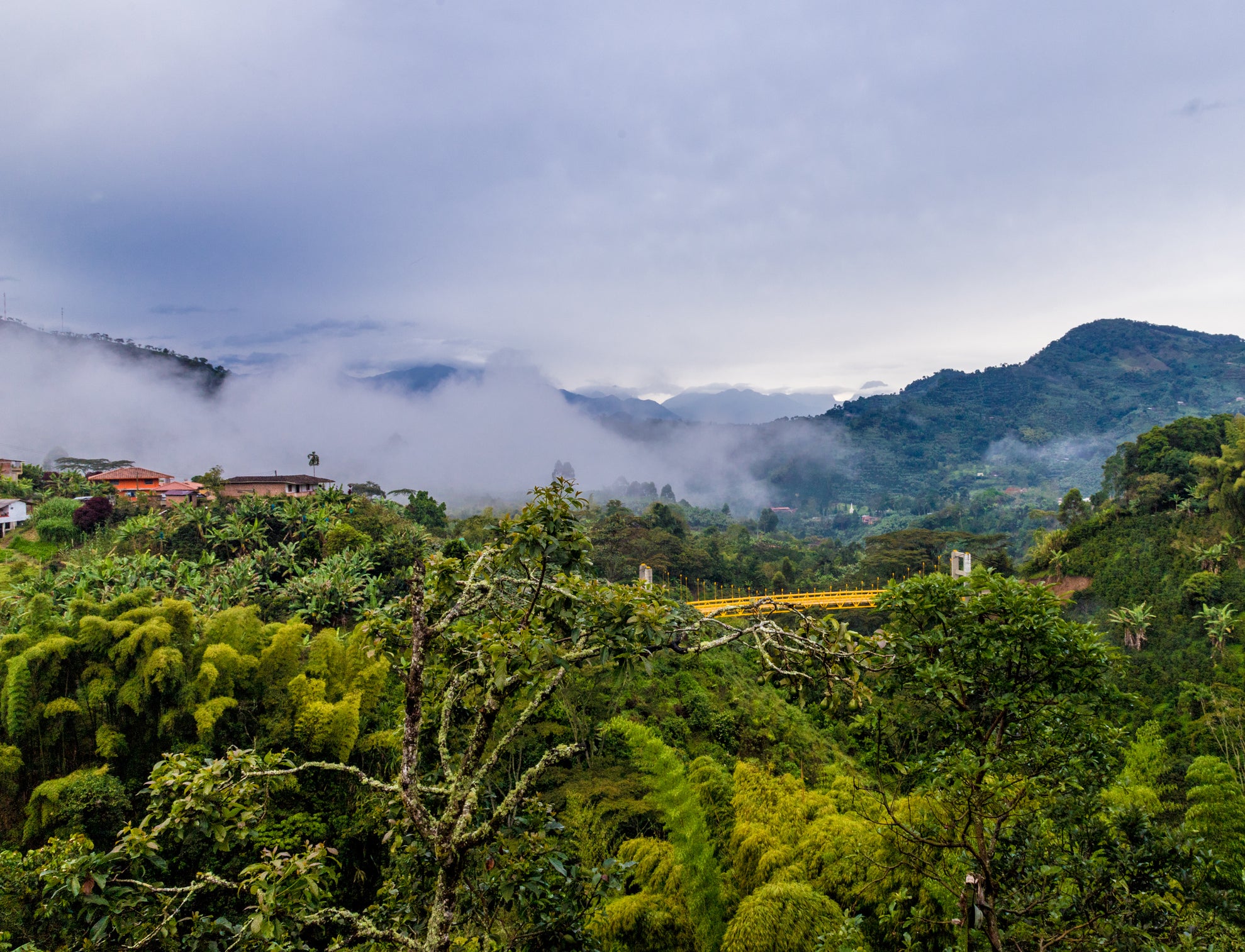 Image of mountain landscape in Colombia with clouds and trees.
