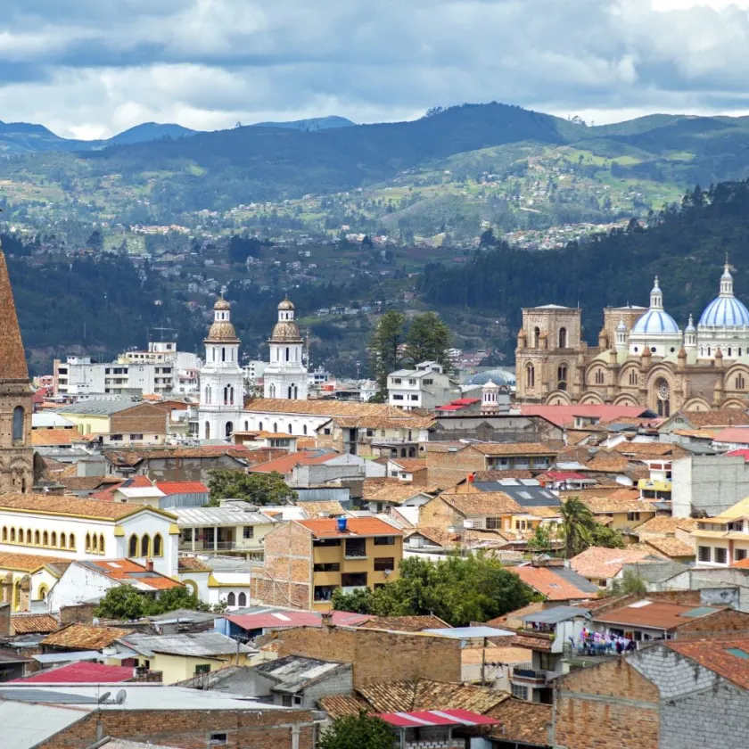 View of a city in the mountain with tiled roofs and many church towers