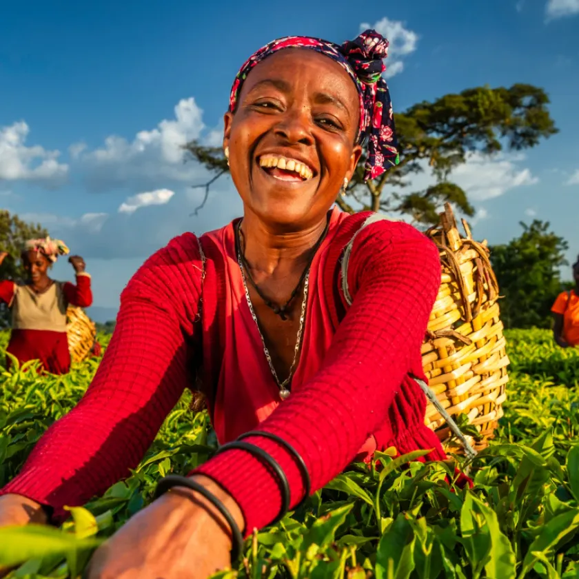 Woman working in a field and smiling