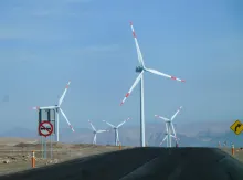 View of a road with several windmills in the background