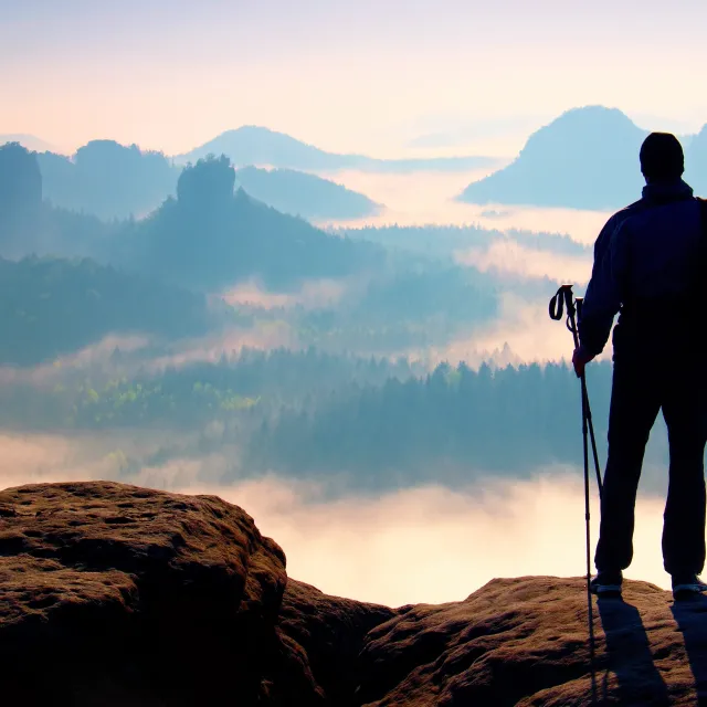 Picture of man standing overlooking a cliff