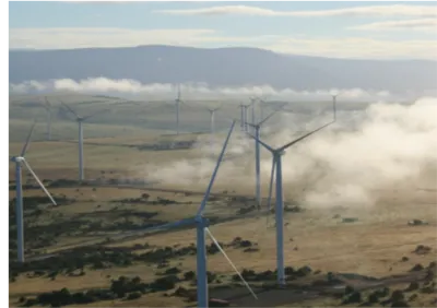 Windmills with a mountain in the back