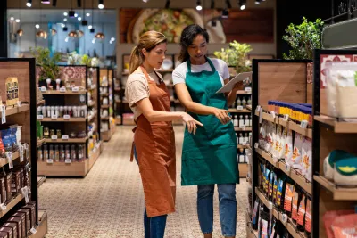 Two retail employees working at a supermarket