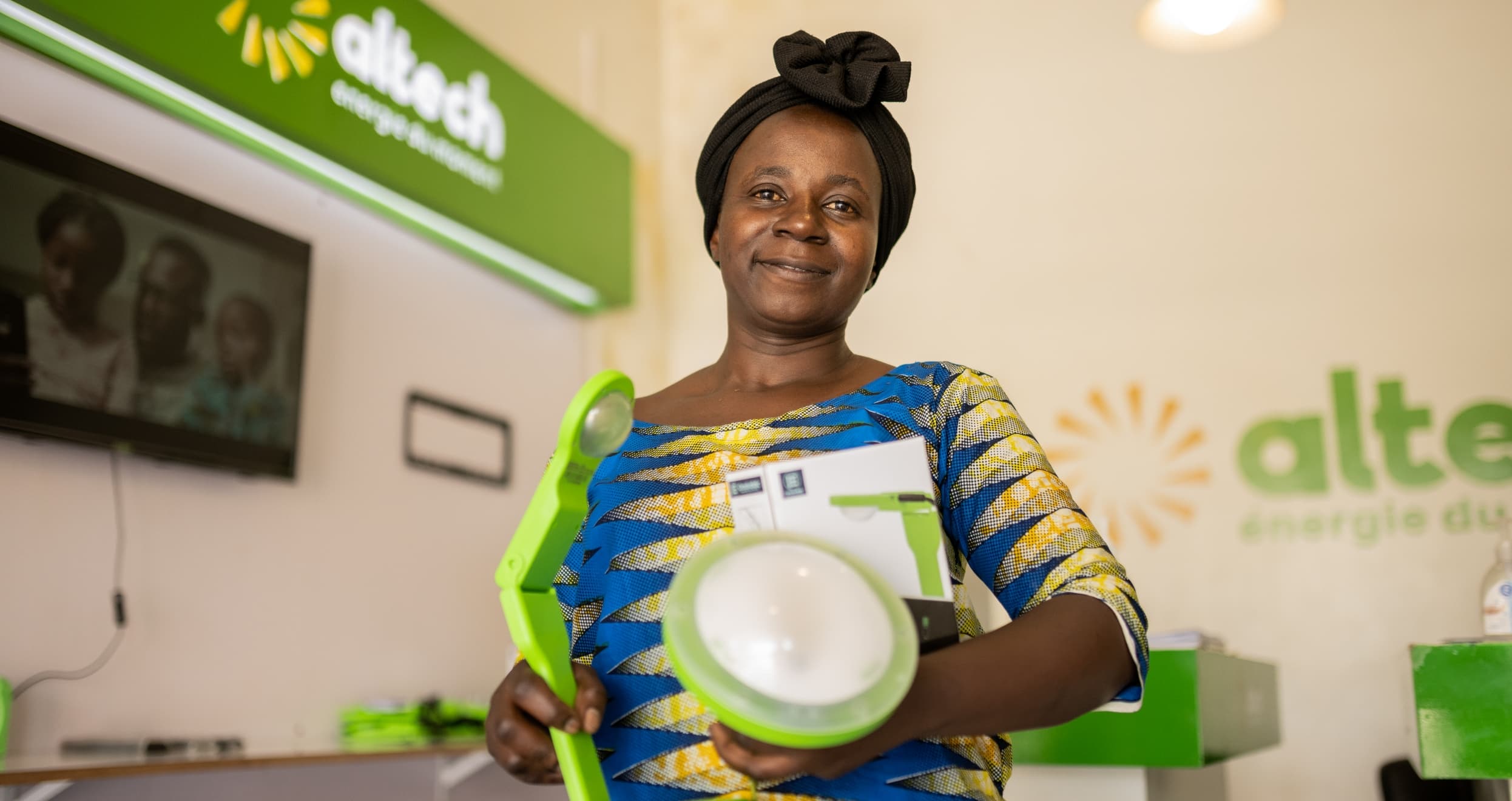 Aimé Bushinga receives her solar light kit from Altech