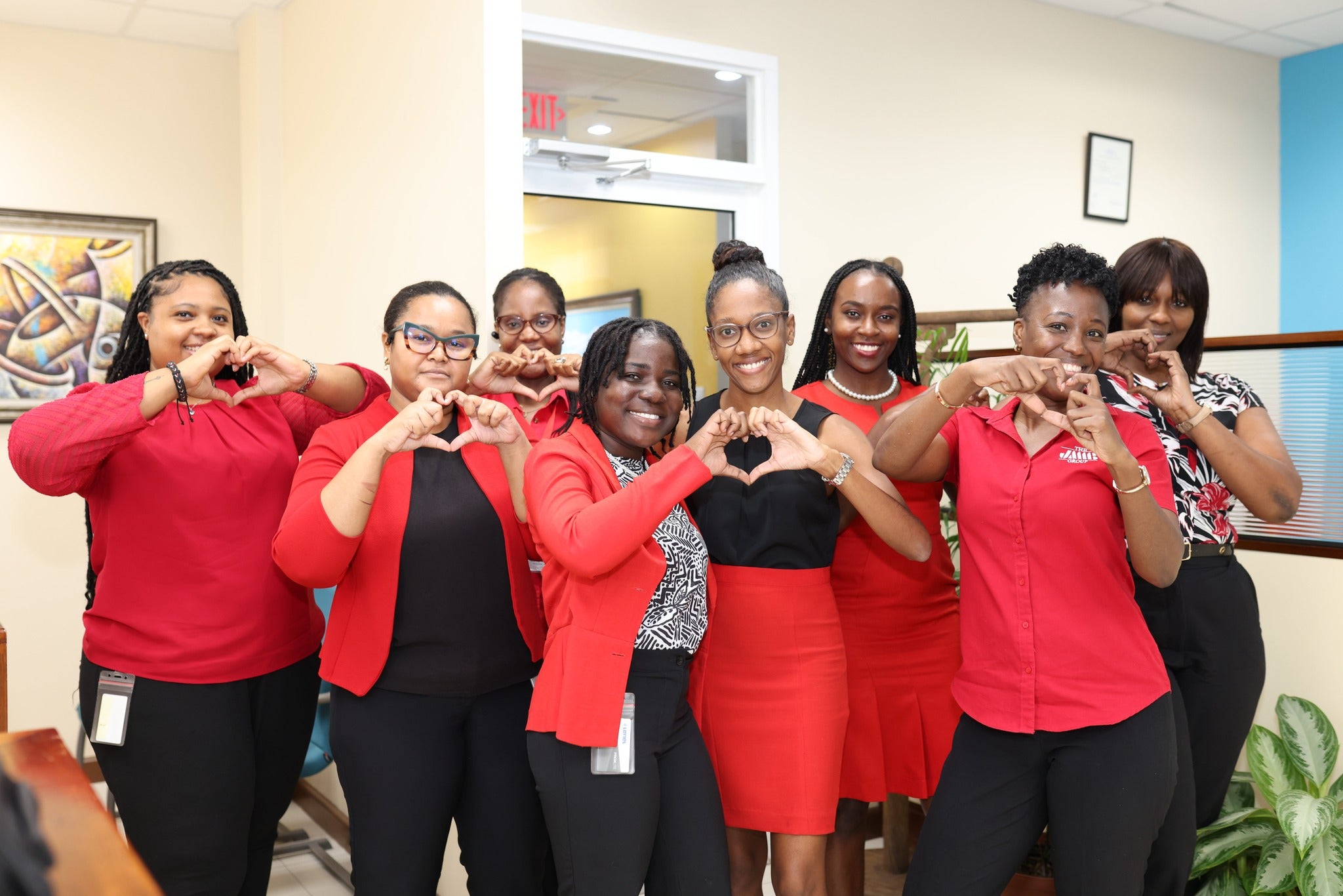Three employees of JMMB smiling during a conference